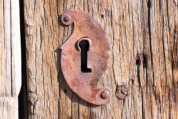 Santa Fe, NM: Antique Rustic Wooden Door and Rusty Keyhole. Close-up shot.