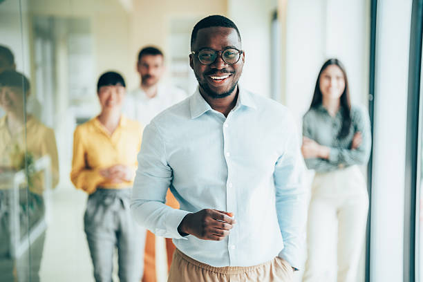 istock Professional team supporting confident colleague at workplace 2255989559