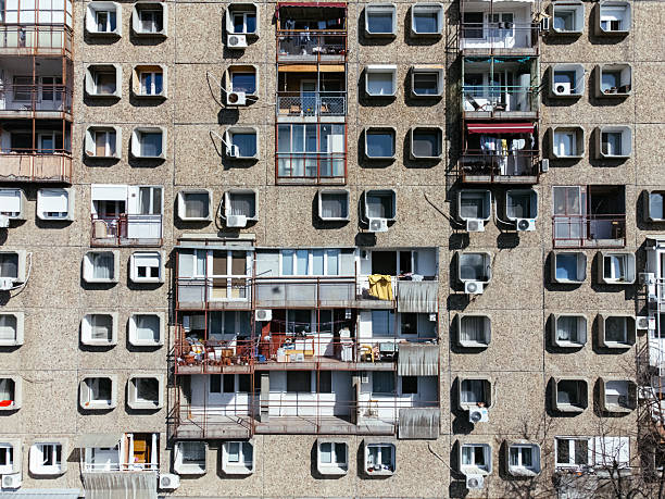 Brutalist apartment building facade with balconies and windows in Televizorke, Belgrade, Serbia, socialist housing. g.