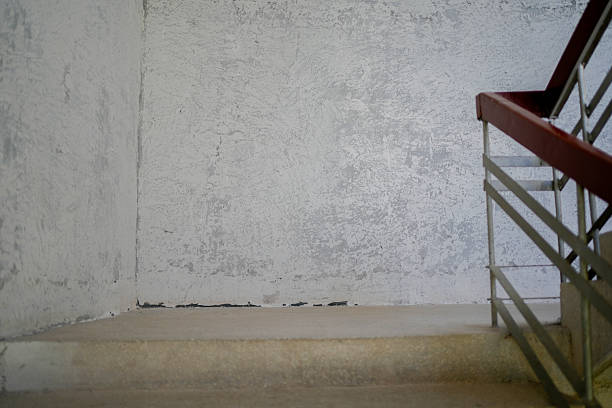 Red Handrail Against Concrete Wall – Industrial Architecture Detail