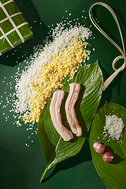 Vietnamese Chung cake ingredients in motion, with mung beans, pork and leaves arranged artistically, modern Tet food concept art