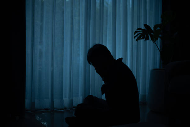 Depressed mid adult man at home