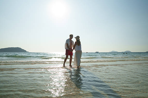The couple enjoyed themselves on the beach at sunset.