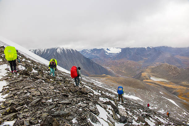 August 17, 2025. Russia. Altai Mountains. A group of tourists descends from the Rublevsky Pass.
