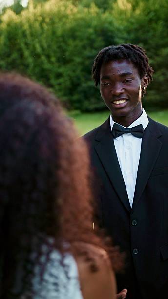 Groom getting ready for wedding with tuxedo and boutionere