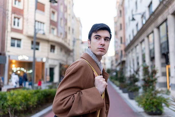 istock Young man walking city street after work in winter 2256014914