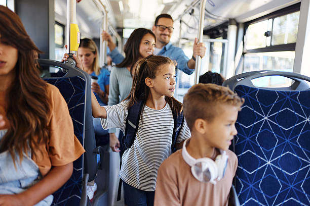 Little girl and her family choosing seats in a public transportation.