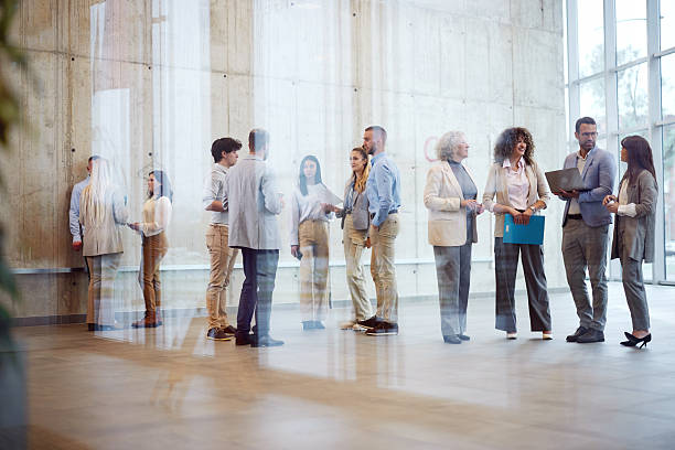 istock Large group of multi-tasking entrepreneurs in a hallway. 2256021055