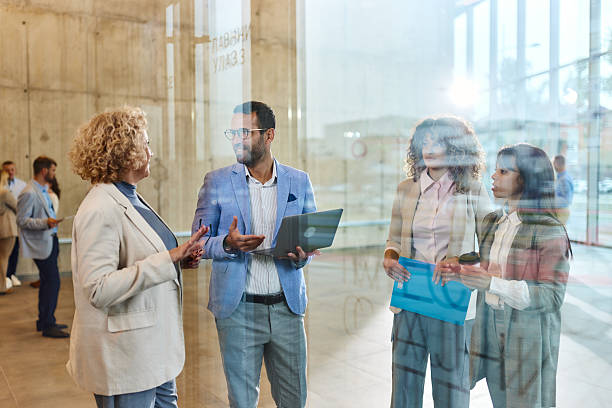 istock Team of business colleagues talking while working in a hallway. 2256021497