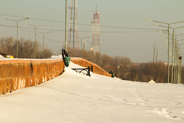 Wooden bench in the public park in snowed. Winter in outdoor.