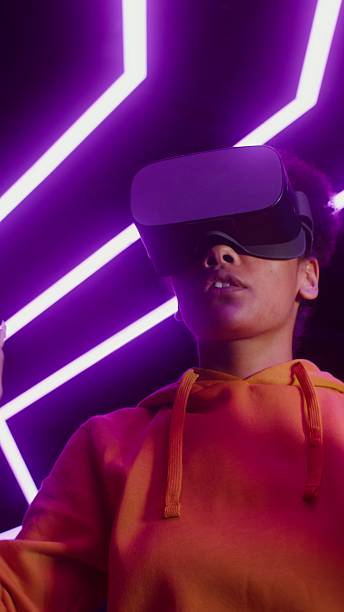 istock A woman in a virtual reality headset plays. 2256030406