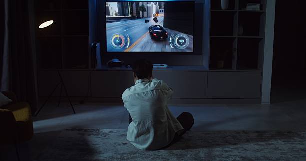 istock Young man playing video games at home in. 2256042509