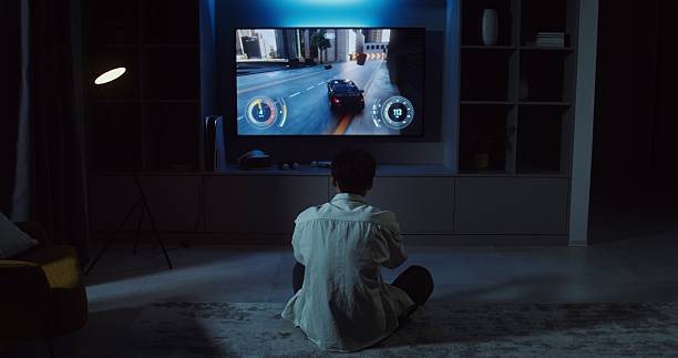 istock Young man playing video games at home in. 2256042535