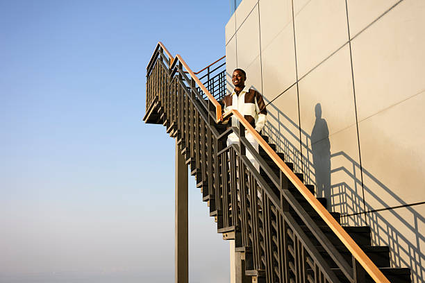 Rear view of man standing at the staircases.