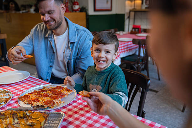 Family enjoying their lunch at pizza restaurant