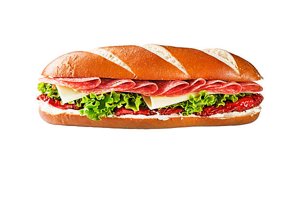 Sandwich with sliced salami, cheese, dried tomato and lettuce isolated on white