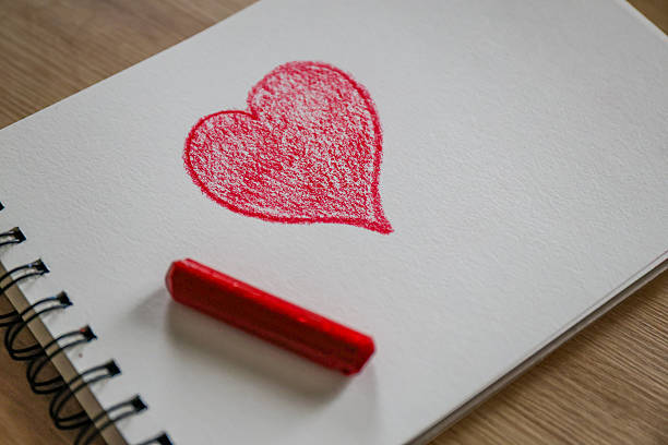 The message of love is written in a notebook with a simple pencil.