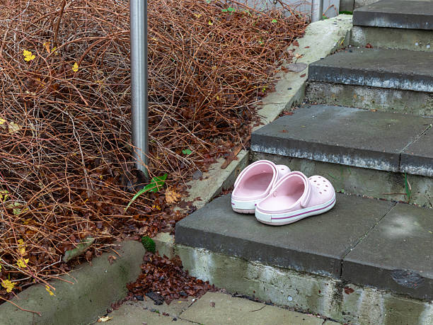 The girl's dirty pink slippers on a white background