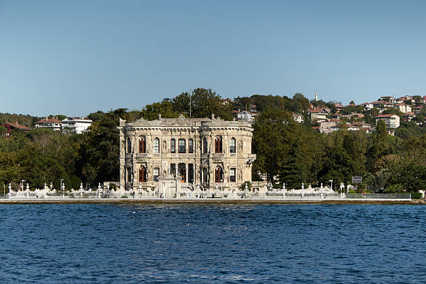 Istanbul / Turkey - May 25, 2010: Dolmabahce palace imposing entrance under deep blue sky. Tourists sightseeing, a sunny day.