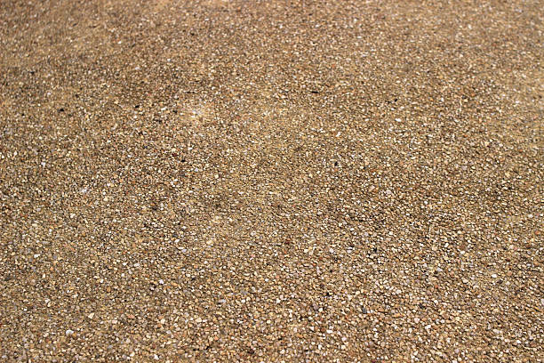 The surface of a small, old, brown stone wall.