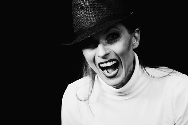 istock Woman wearing hat with open mouth shouting in studio portrait 2256060885