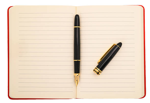 Agenda with fountain pen isolated on white background