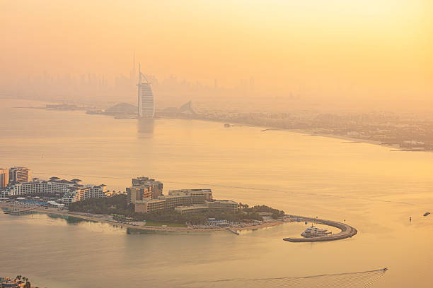 Dubai UAE aerial rooftop view from Burj Khalifa in clouds. Famous fountain and downtown