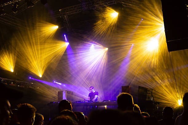 Dj playing techno music on the summer night concert.