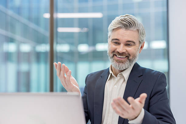 istock Mature businessman having online video call communicating through laptop 2256073396