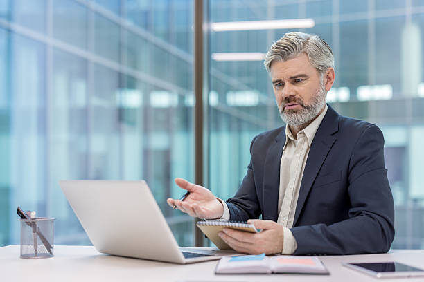 istock Mature businessman having video conference call in office 2256073748