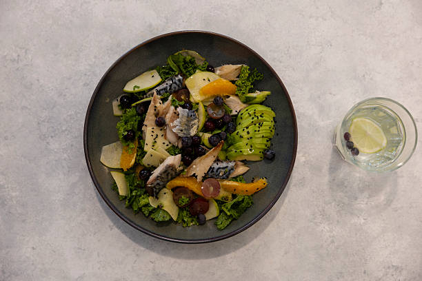 Fish and fruit salad on a marble floor.