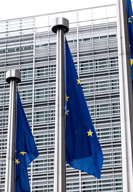 istock EU Flags Waving On Flagpoles Against European Commission Building 2256080237
