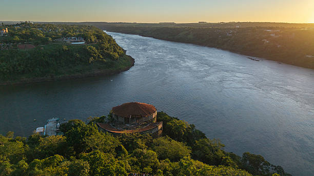 Aerial shot at sunset of the triple border between the Paraná and Iguaçu rivers, separating Brazil, Argentina, and Paraguay