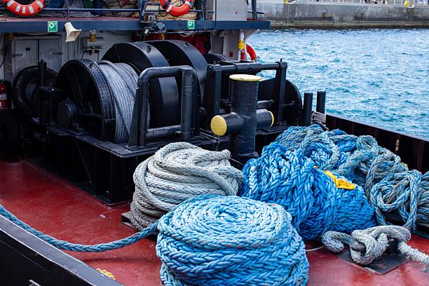 Piles of ropes and winch on tugboat