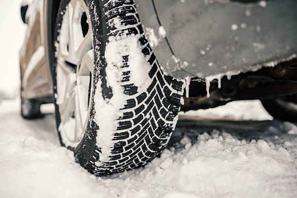 istock Car winter tire treading through deep snow 2256089778
