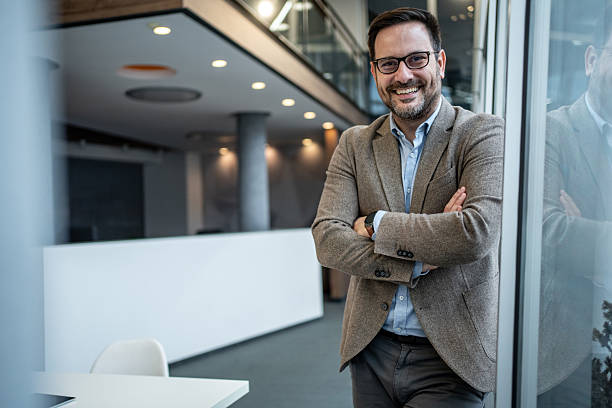 istock Confident businessman smiling standing in modern office 2256097651