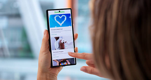 istock Generous Young Woman Using Smartphone To Donate Money 2256113359