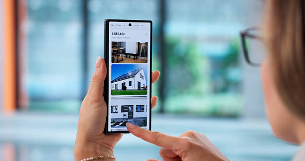 istock Young Woman Using Smartphone To Search For Real Estate Properties 2256113377