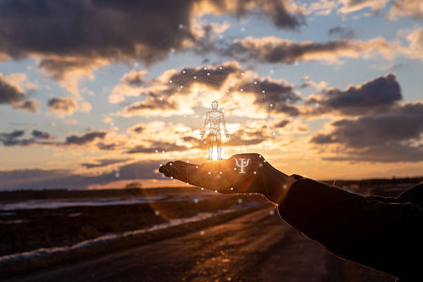 Ai and human psychology. A hand cradles a glowing figure at sunset, symbolizing AI's mental insights.