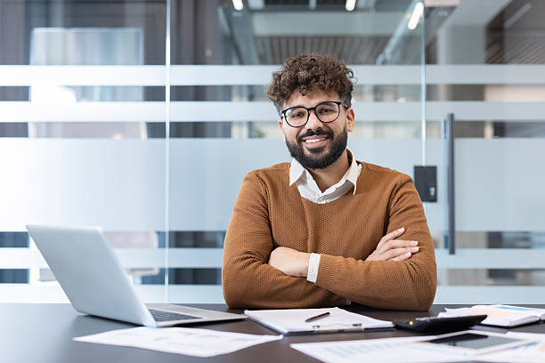 istock Confident businessman smiling at modern office desk 2256122527