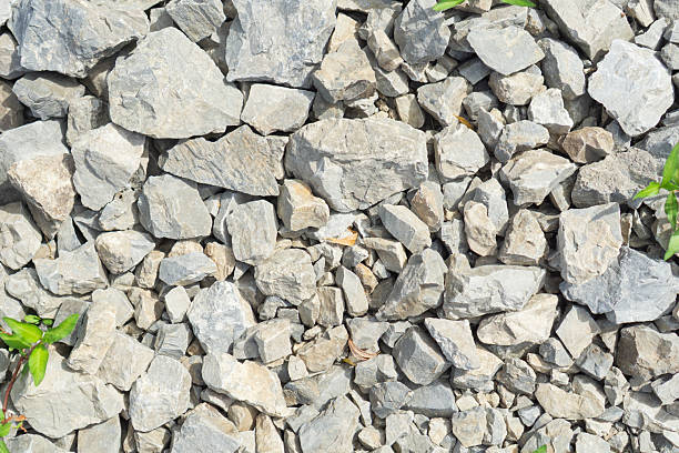 Mixed light-colored river stones and pebbles creating a natural texture, suitable for landscaping companies, construction material suppliers, and outdoor design firms. High quality photo