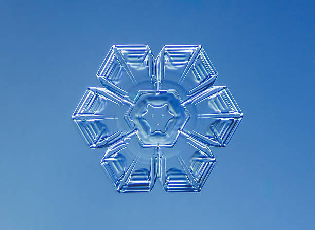 Natural snowflake crystal in blue background.
