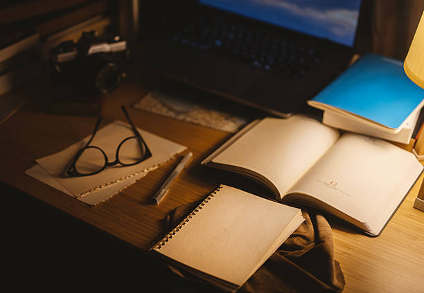 Creative workspace with analog camera, notebook and laptop on wooden desk