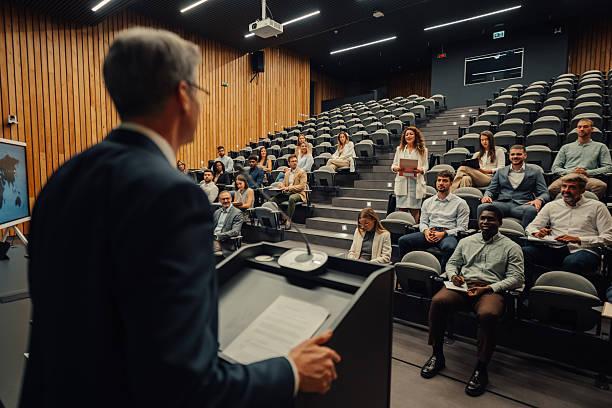 istock Business professional giving presentation to diverse audience at conference 2256125052