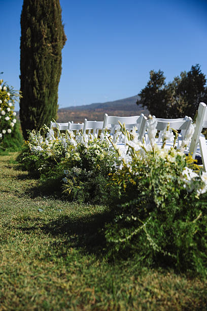 Romantic wedding ceremony. Beautiful setting for outdoors wedding ceremony waiting for bride and groom and guests. Decoration
