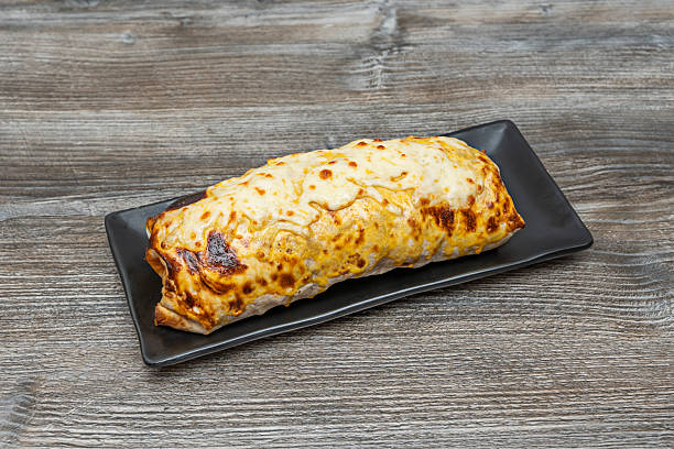 Mexican food dish on wooden table,chimichanga is a deep-fried burrito.