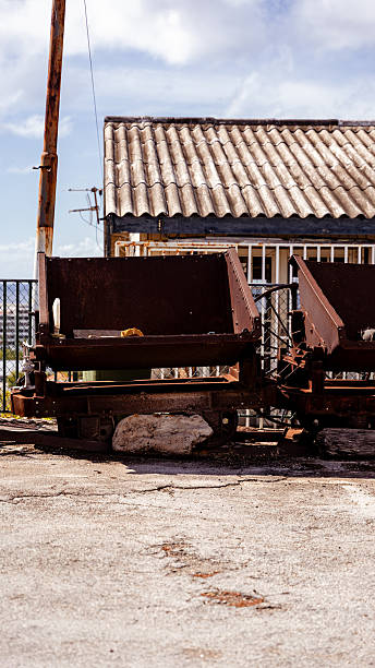 Rusty industrial mine carts at an old phosphate mining site in curacao