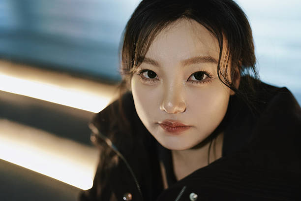 The city's night is gently spread by warm yellow light strips. The girl sits on the glowing path, her fingertips brushing the screen, and a smile spreads with the evening breeze. Warm light outlines her relaxed silhouette— in this moment, both the night and her mood are perfect.