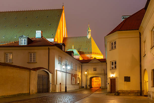 Evening view of St Johns Archcathedral in Old Town Warsaw Poland with illuminated street