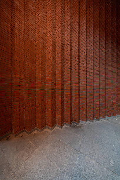 The exterior wall of a red brick building